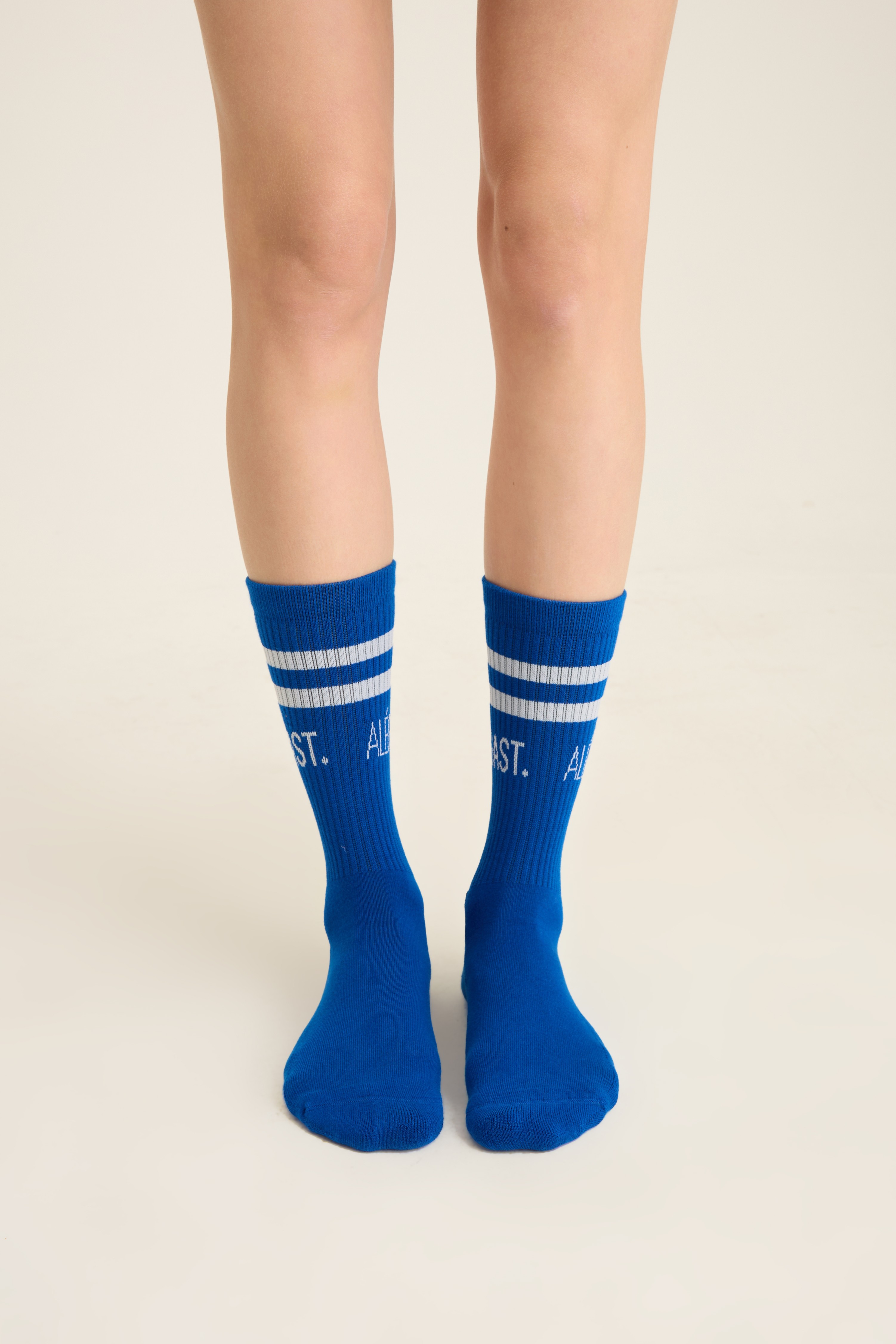 Royal blue ribbed socks with white sport stripes and a knit logo