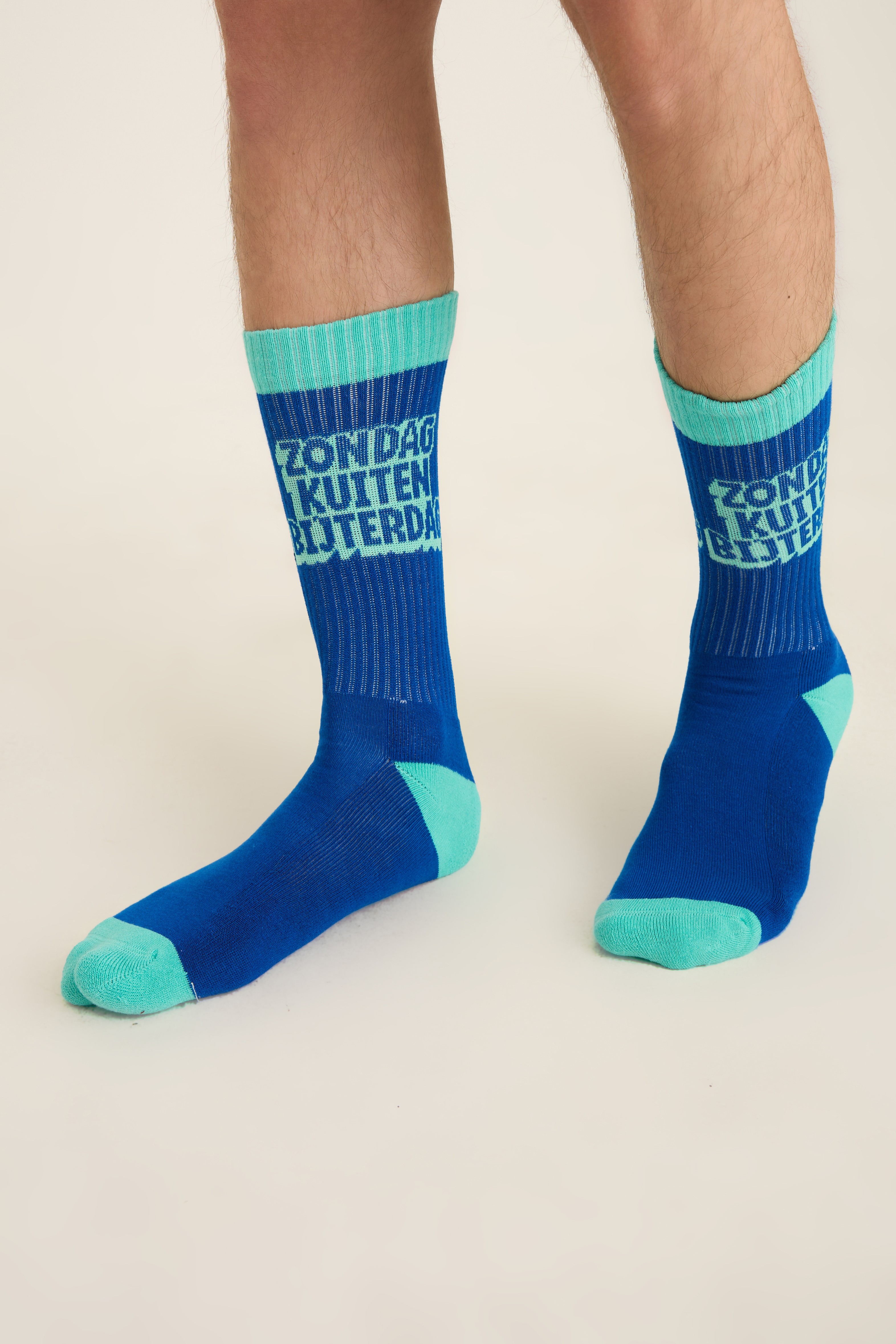 Blue and teal college-style socks with knit lettering and contrast heel and toe