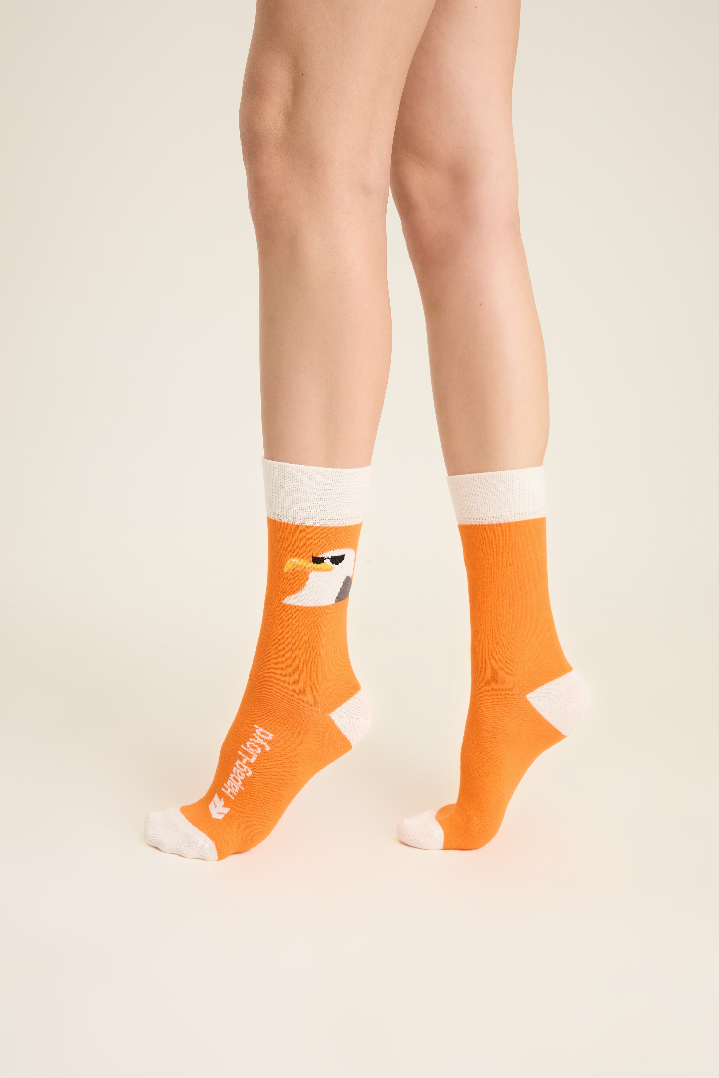 Orange crew socks with a character motif and white contrast cuff