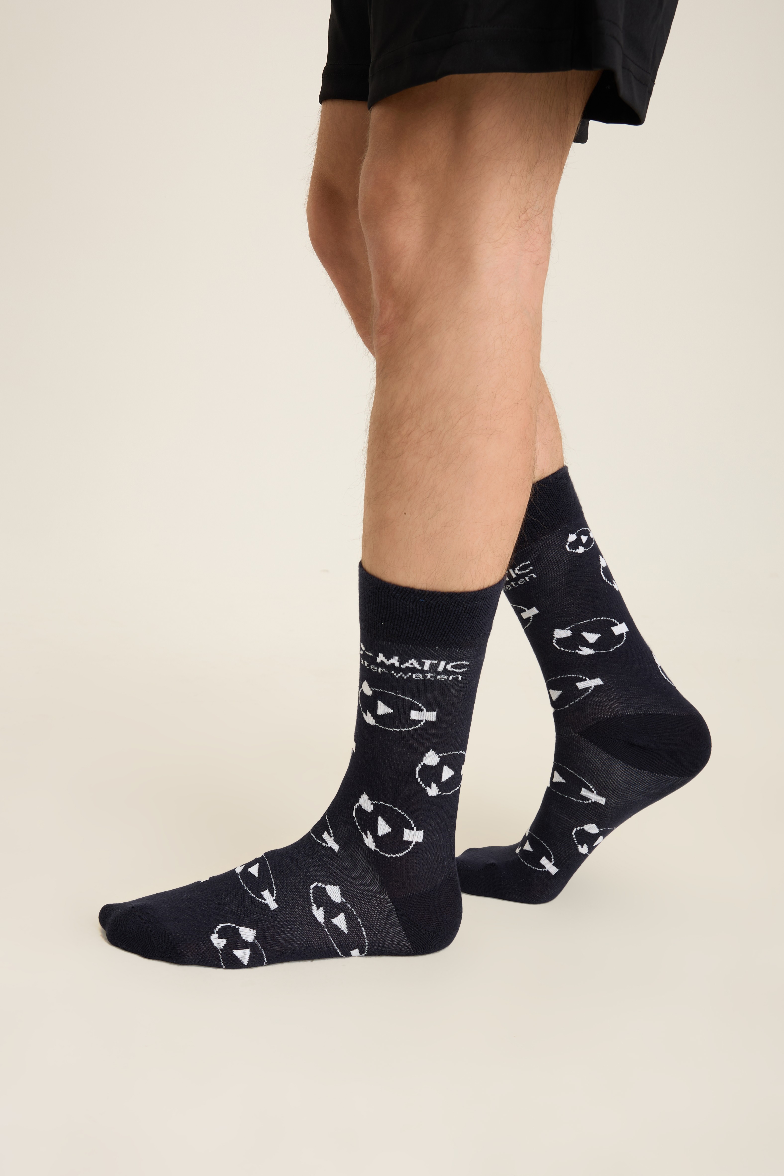 Navy socks with a repeating white all-over motif and knit-in wordmark