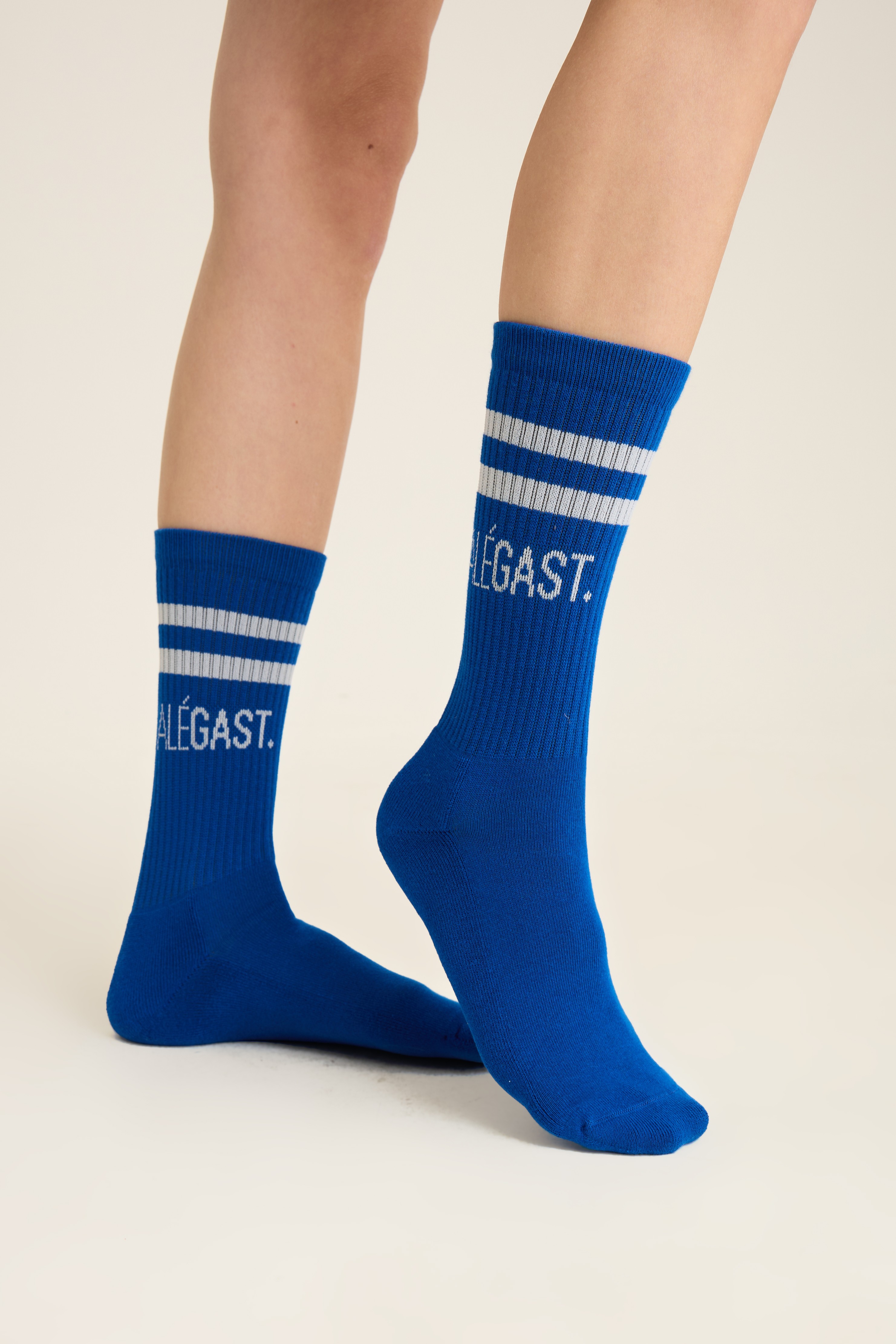 Royal blue varsity socks with double white stripes and knit lettering