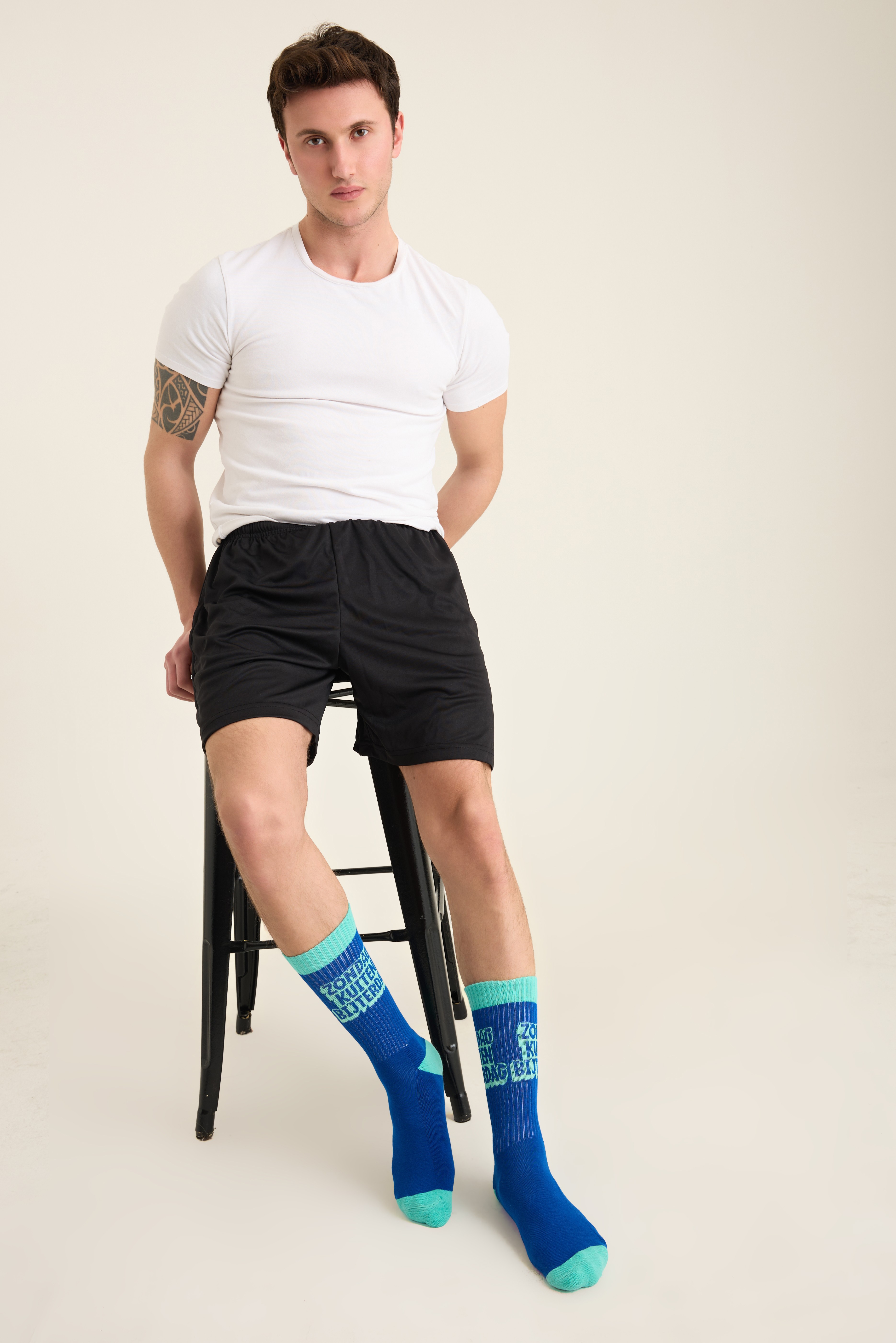 Male model wearing blue and teal college-style crew socks